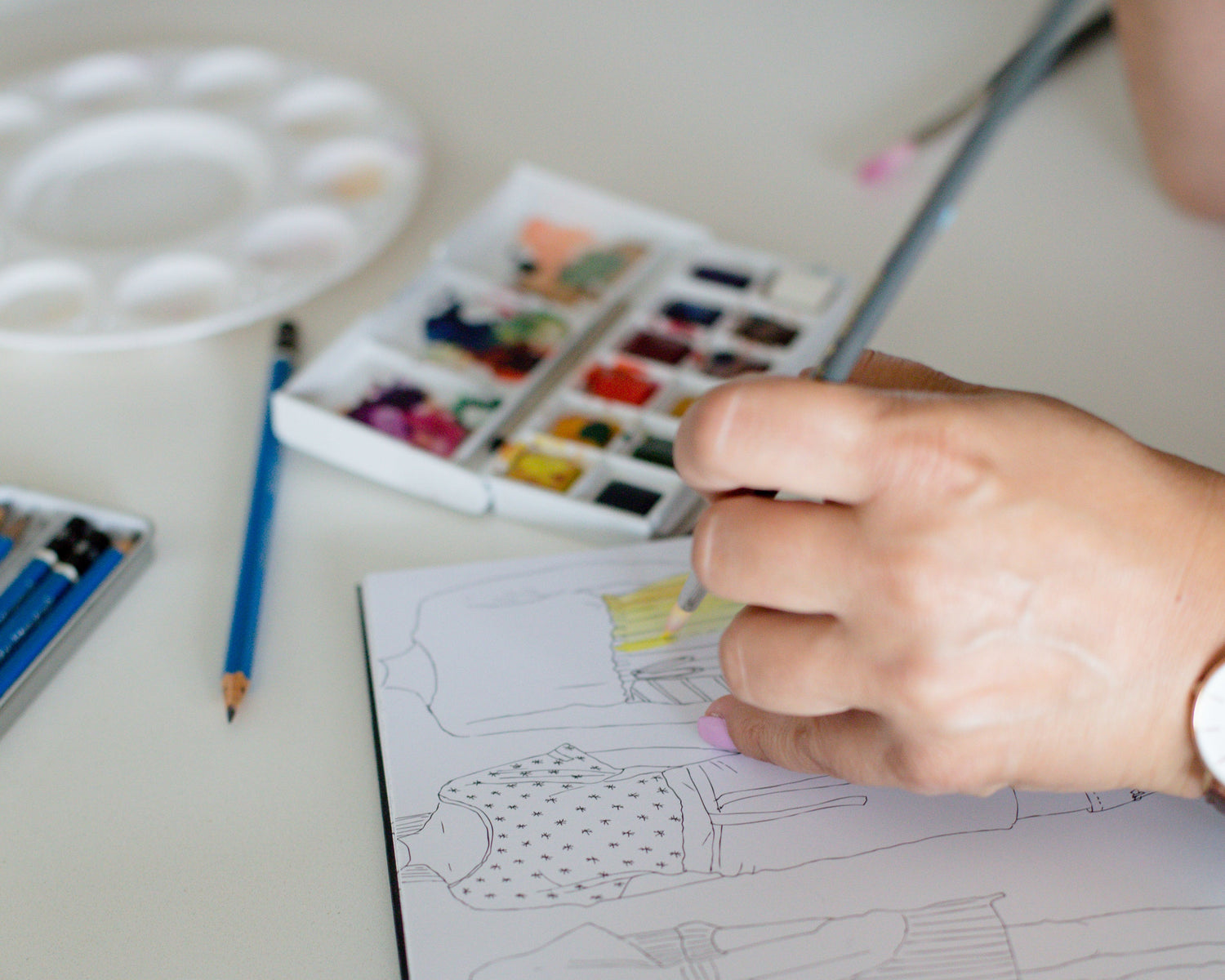 person watercoloring on fashion art