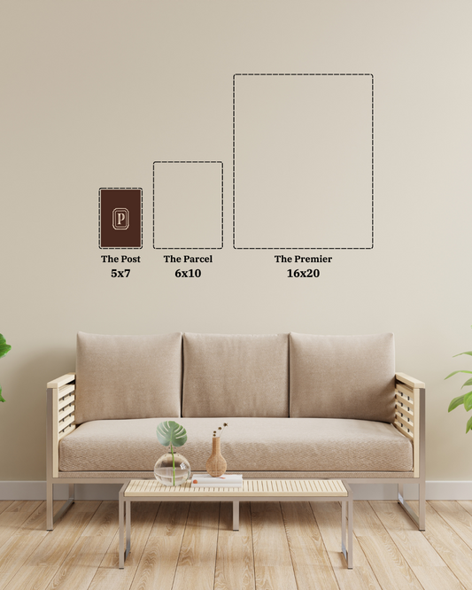 Beige sofa in a living room with wall art dimensions displayed.